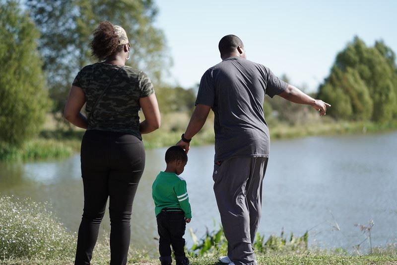 Couple and Little Boy by the Water