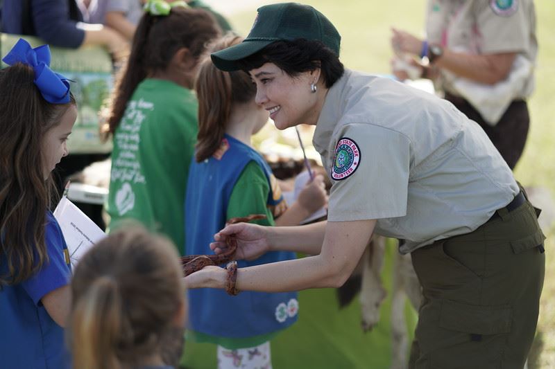 Woman Showing Children a Snake